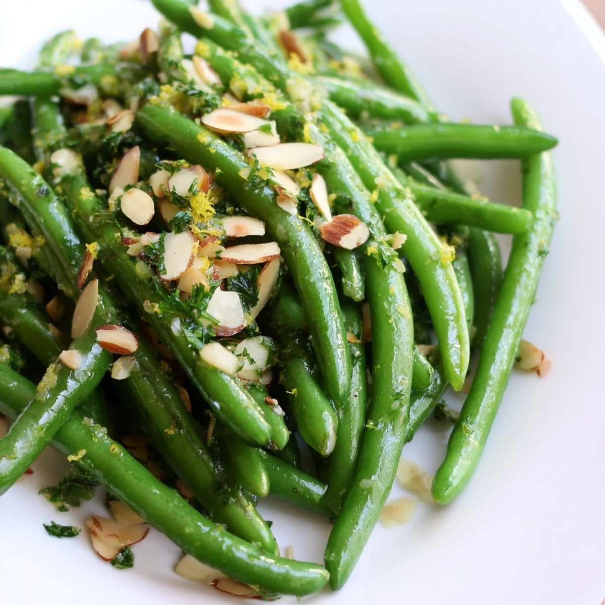 Bright, crisp Lemon Green Beans on a platter topped with toasted almonds and fresh parsley, a perfect gluten-free side dish.