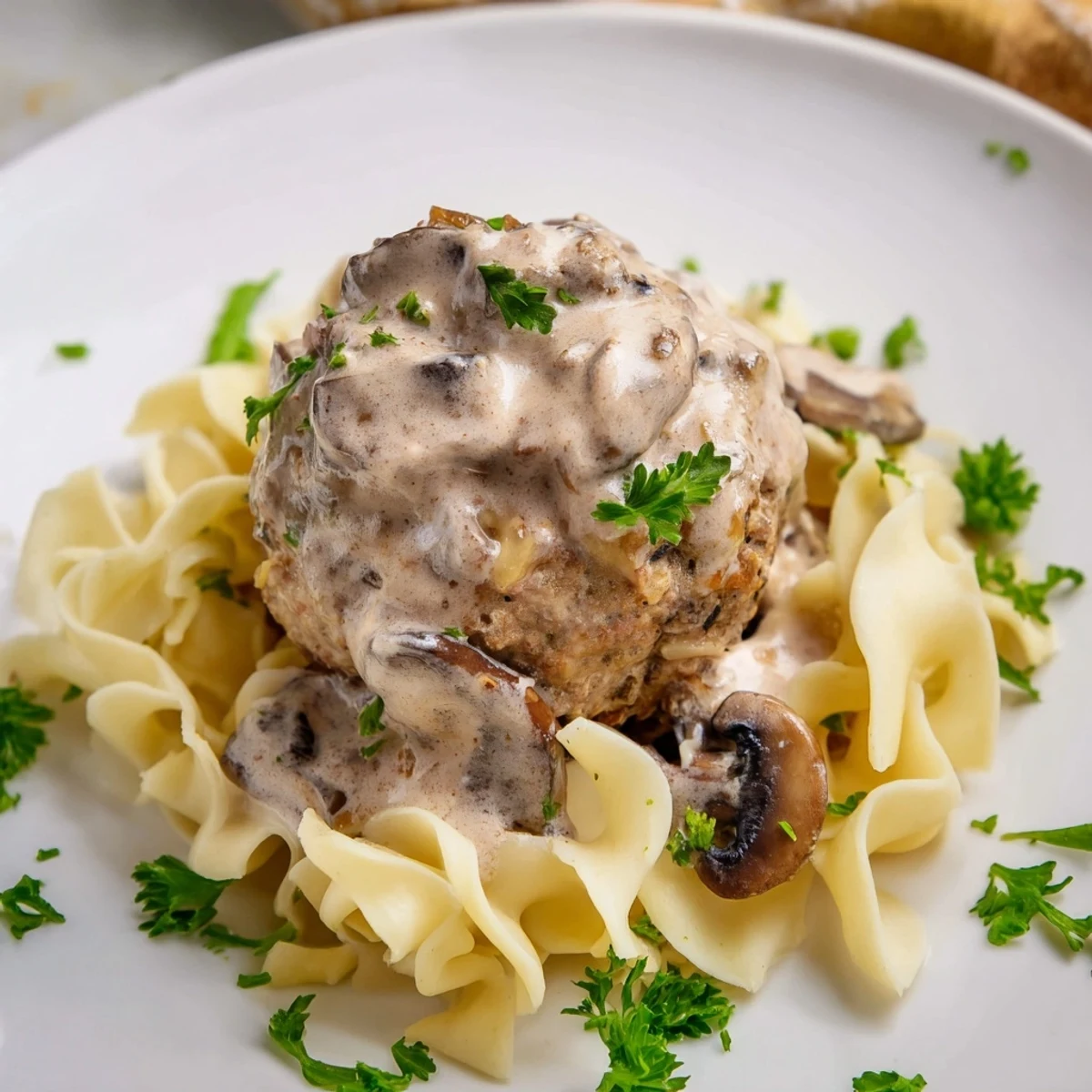 Savory Turkey Meatball Stroganoff is garnished with fresh parsley, served hot as a comforting main dish.