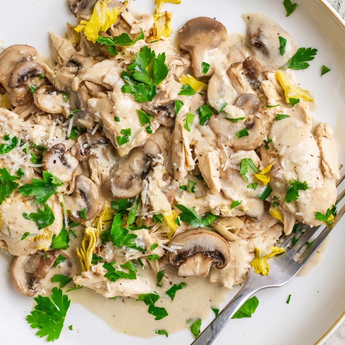 A close-up of the creamy mushroom chicken skillet, featuring golden-brown chicken and garlic-infused mushroom sauce.