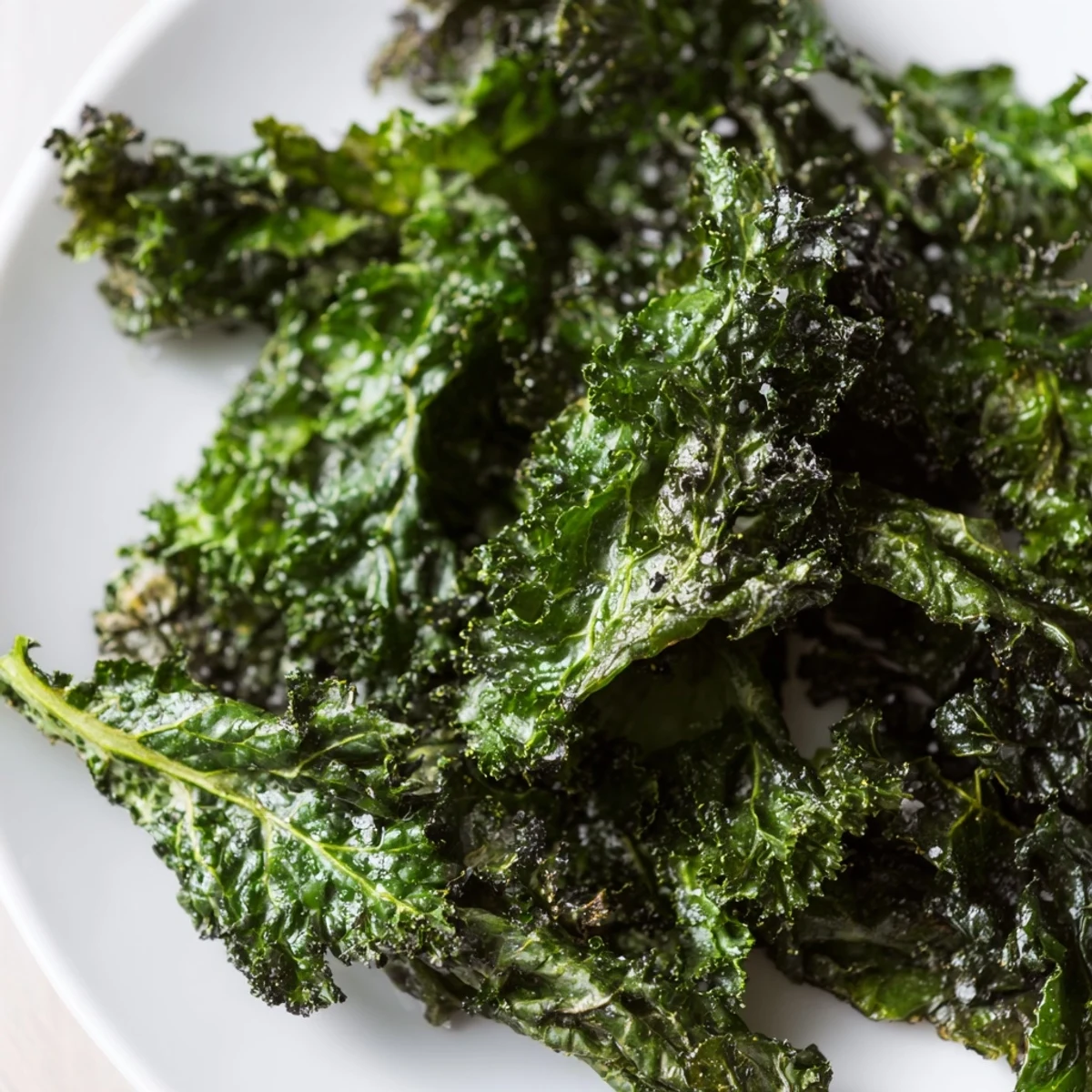 Freshly baked Green Kale Chips with Sea salt showing crunchy edges, perfect for a healthy vegan snack.
