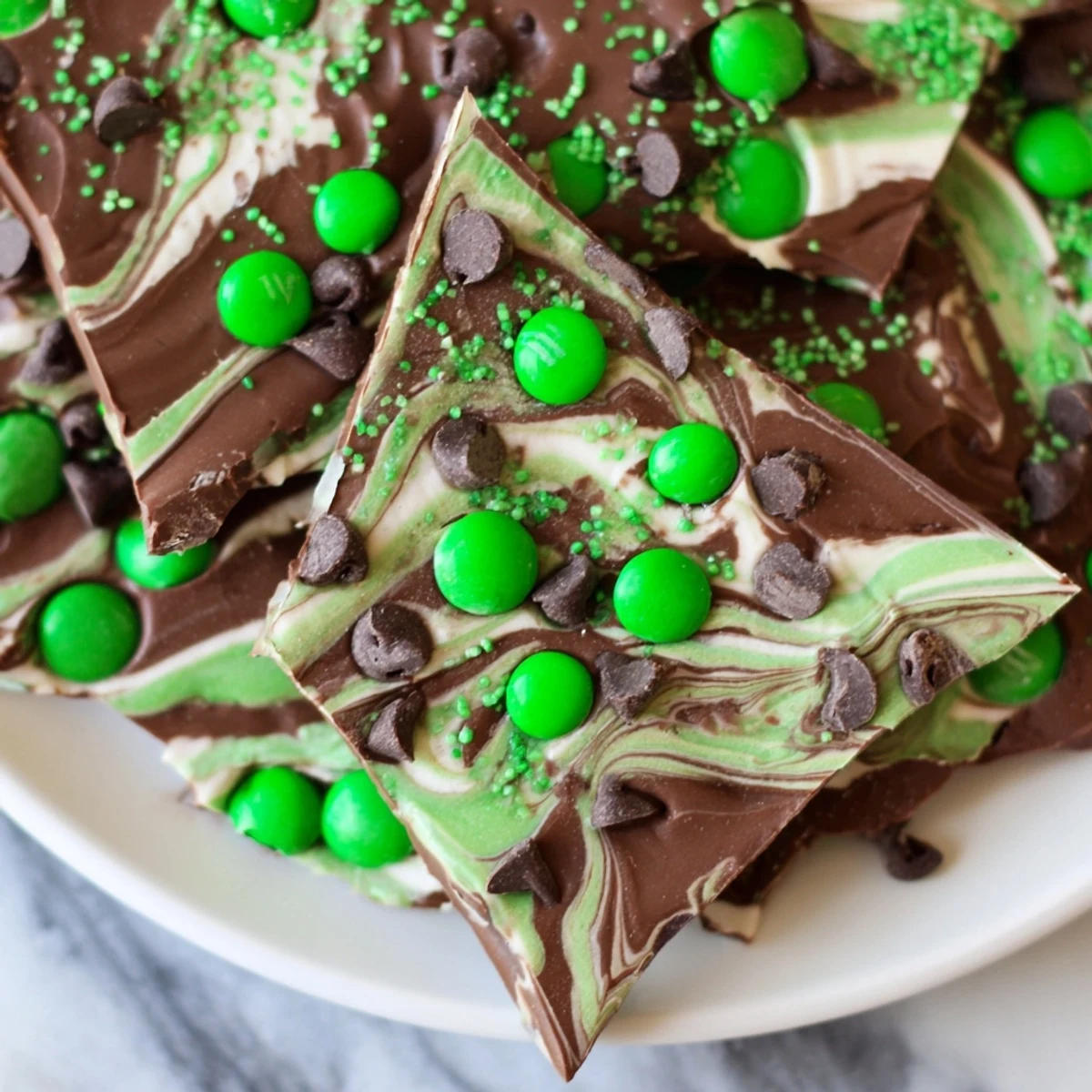 A close-up of St. Patricks Day Mint Chocolate Bark, showcasing marbled semisweet and white chocolate layers.