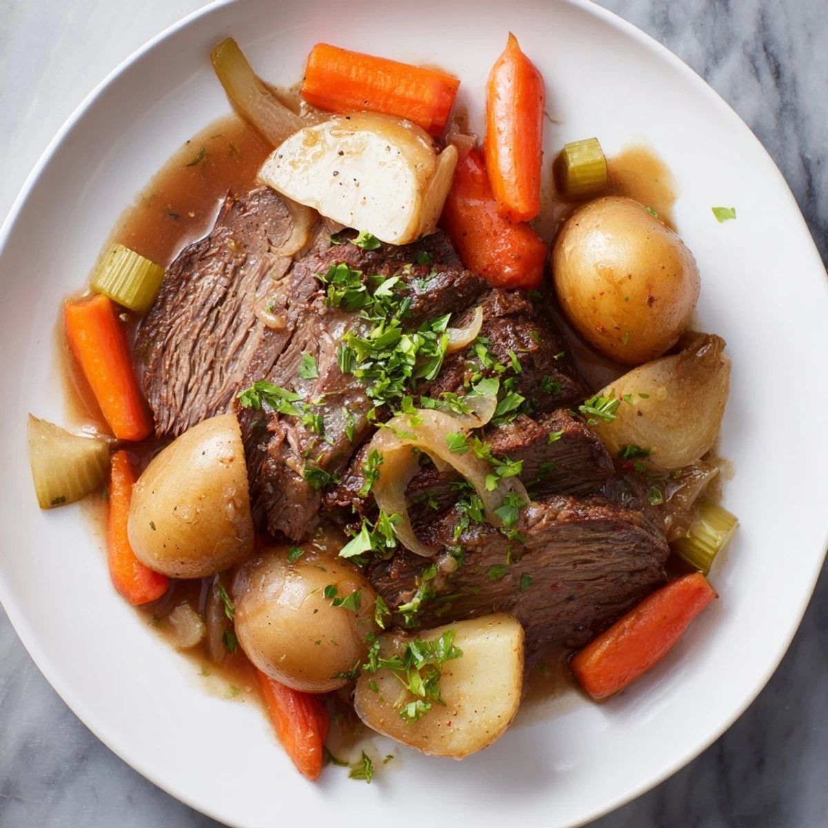 Savory Irish Beef Pot Roast with tender chunks of slow-cooked beef, parsnips, and celery, bubbling in a hearty stew inside a cast iron Dutch oven.