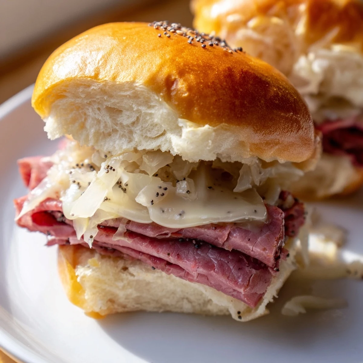 Close-up of Corned Beef Sliders with Swiss Cheese, showcasing melted Swiss cheese and golden brushed butter tops.