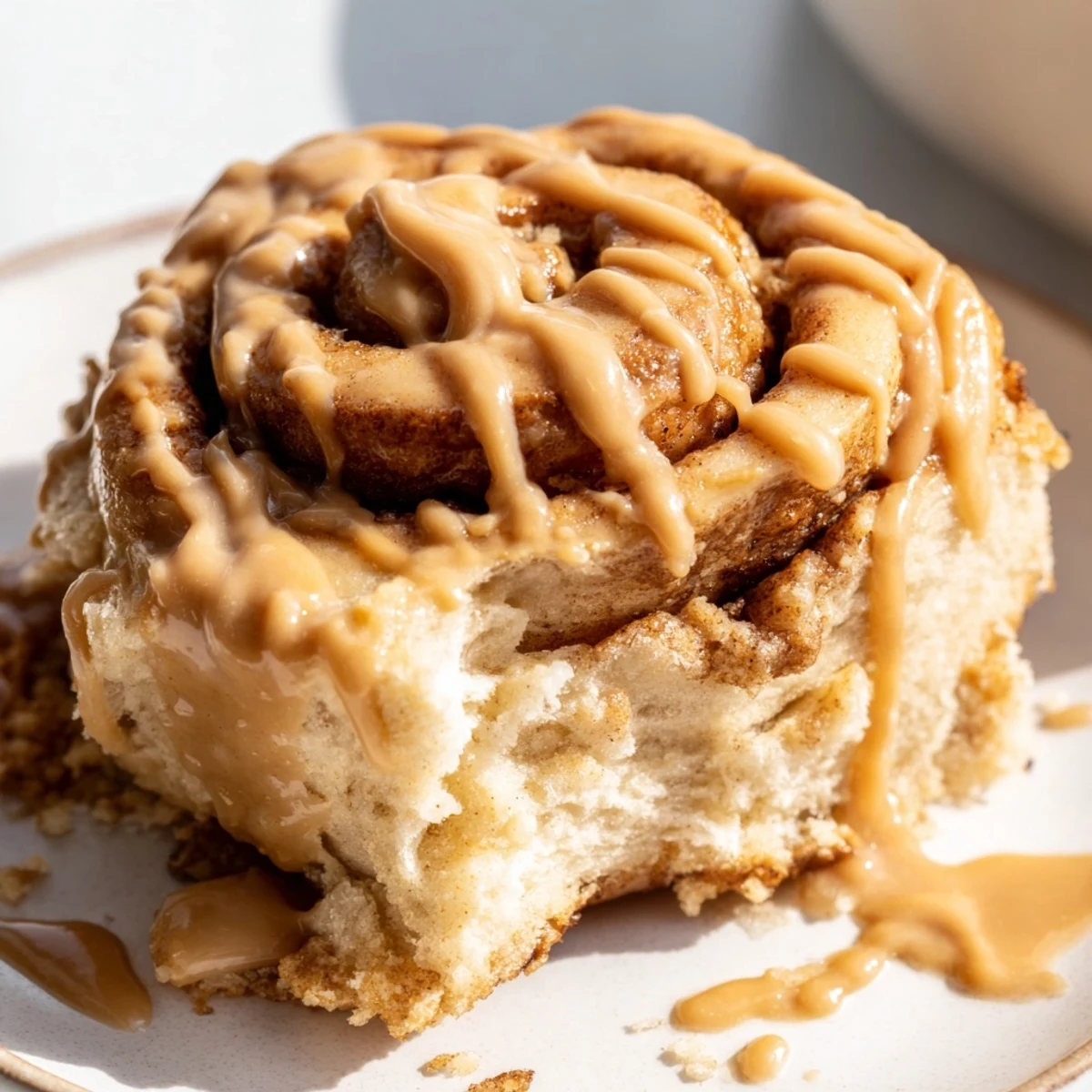Golden-brown Soft and Gooey Biscoff Cinnamon Rolls with creamy Biscoff glaze drizzled over the top.