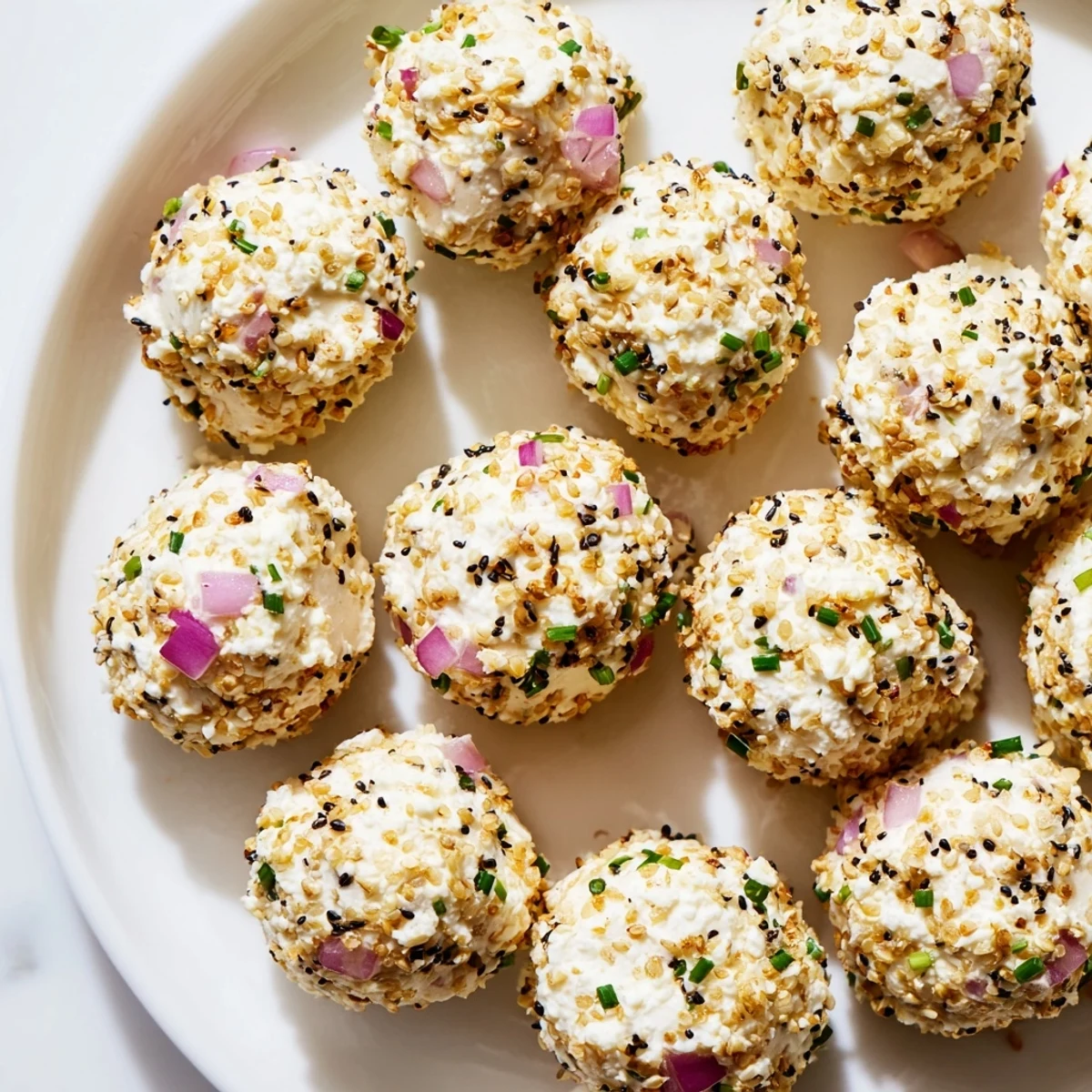 Close-up shot of Everything Bagel Cottage Cheese Bites showing a golden sesame seed and poppy seed coating, ideal for a gluten-free snack or party tray.