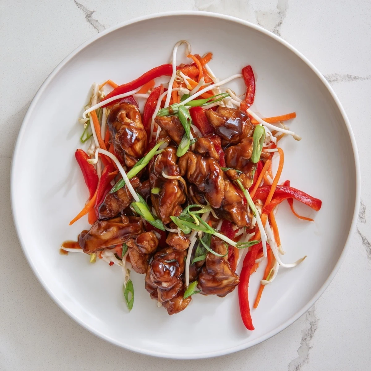 A vibrant plate of Peking Style Chicken featuring crispy veggies and succulent meat, ready to enjoy.