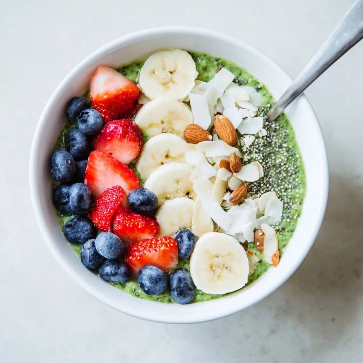 Creamy Matcha Protein Overnight Oats layered with fresh berries in a glass jar for a healthy breakfast.