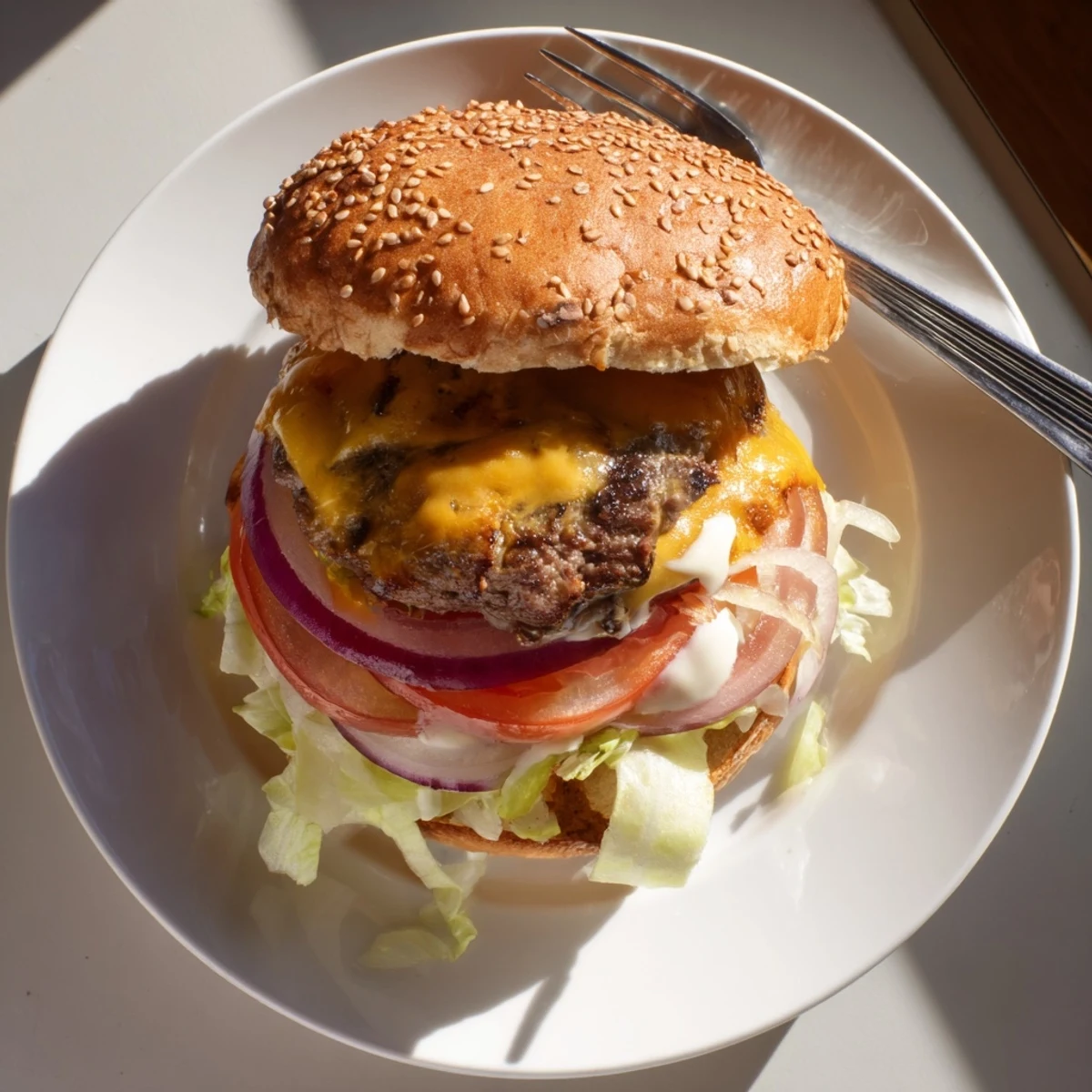 Juicy homemade smash burger stacked with tomato, red onion, and melted cheddar on golden brioche