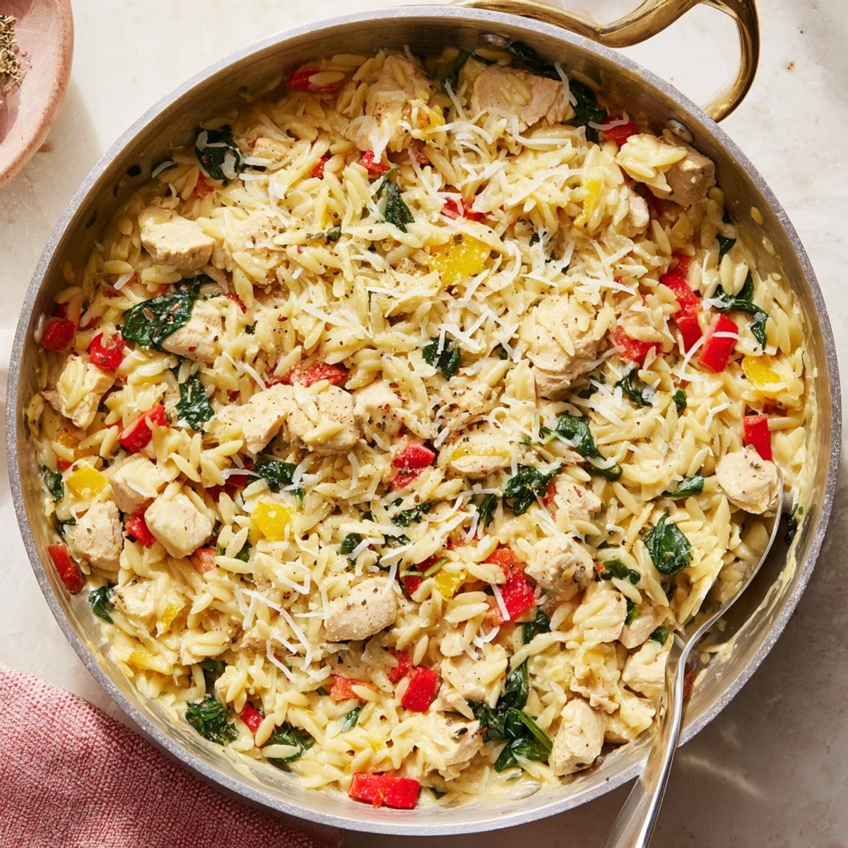 Savory Italian-style cheesy chicken risoni served hot with grated Parmesan and red pepper flakes