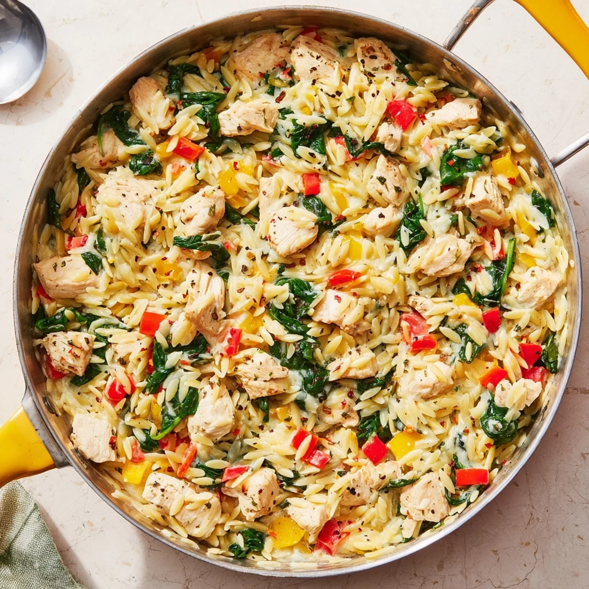 One-pan 30 minute cheesy chicken risoni featuring tender pasta and diced chicken in rich sauce