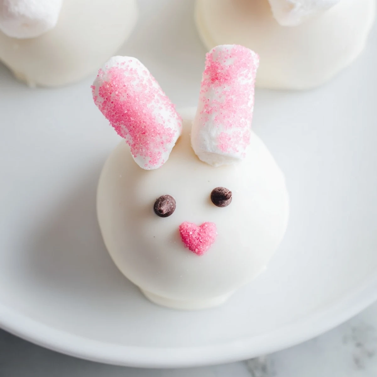 Easter dessert featuring no-bake Bunny Oreo Balls with cute bunny faces and white chocolate coating