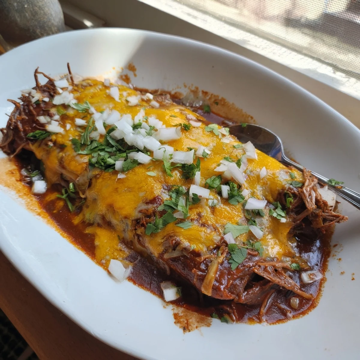 Crispy corn tortilla enchiladas stuffed with juicy shredded birria beef and cheese