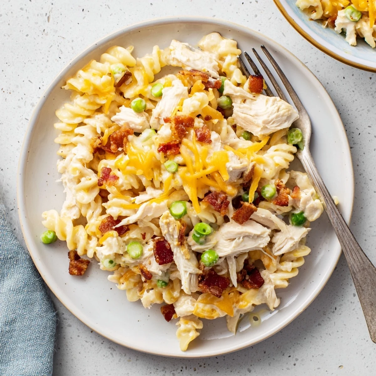 Creamy Crock Pot crack chicken casserole topped with melted cheddar and crispy bacon crumbles