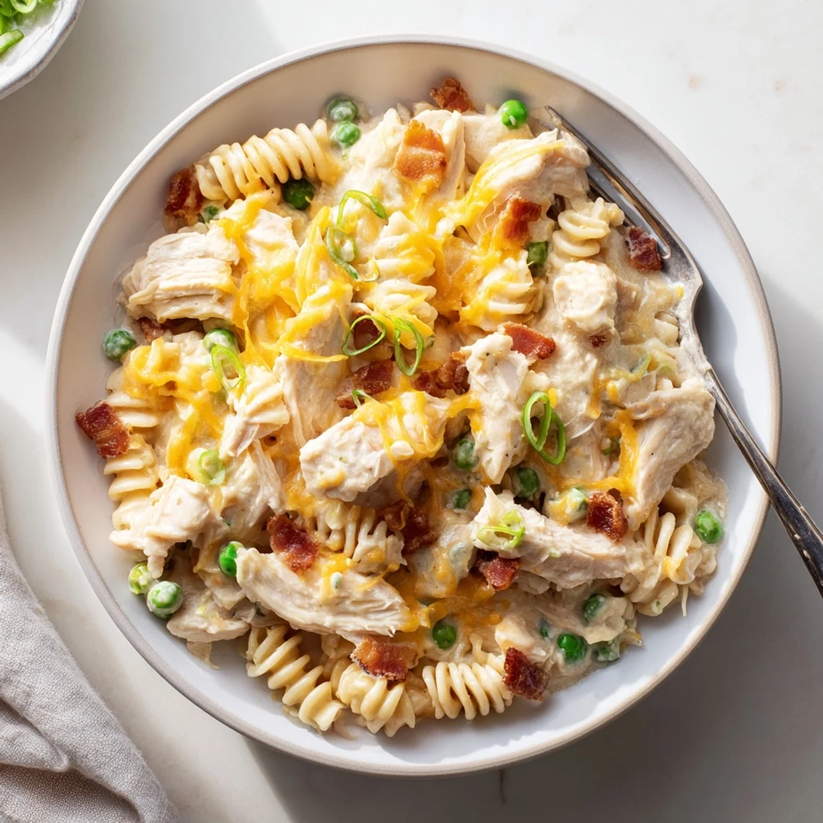 Golden slow cooker chicken casserole loaded with tender pasta in rich creamy cheese sauce