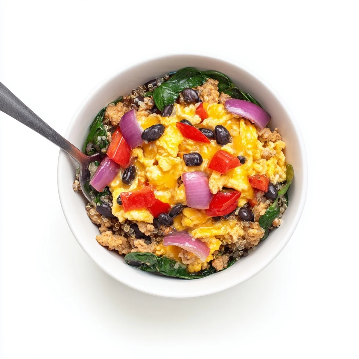 Protein packed breakfast meal prep bowl with scrambled eggs, sausage crumbles, spinach, and shredded cheese topping