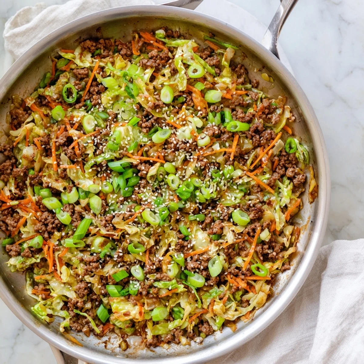 Crisp shredded cabbage and ground pork simmer together in this easy one-pan egg roll in a bowl