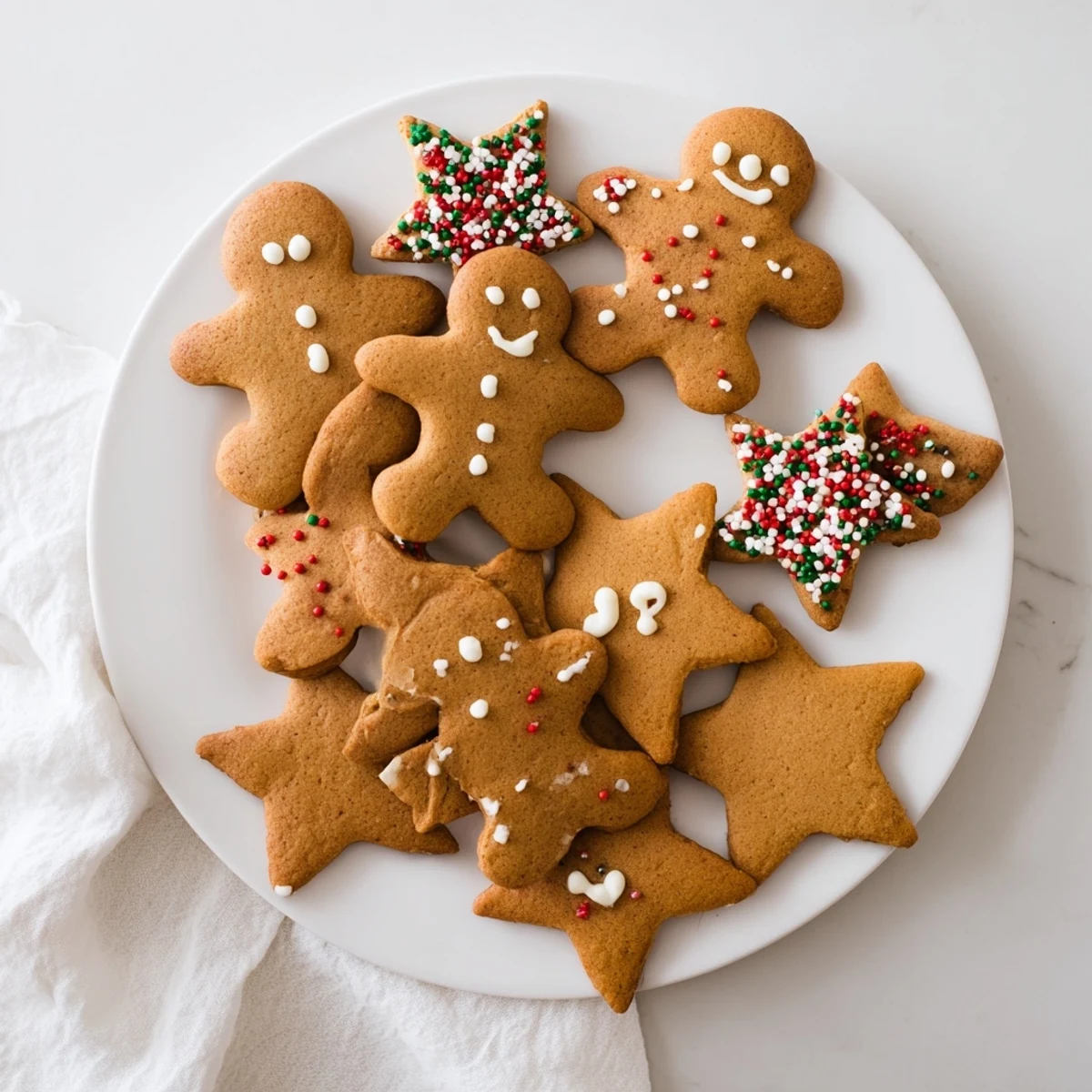 Soft spiced classic cut out gingerbread cookies shaped like stars and hearts ready for holiday decorating