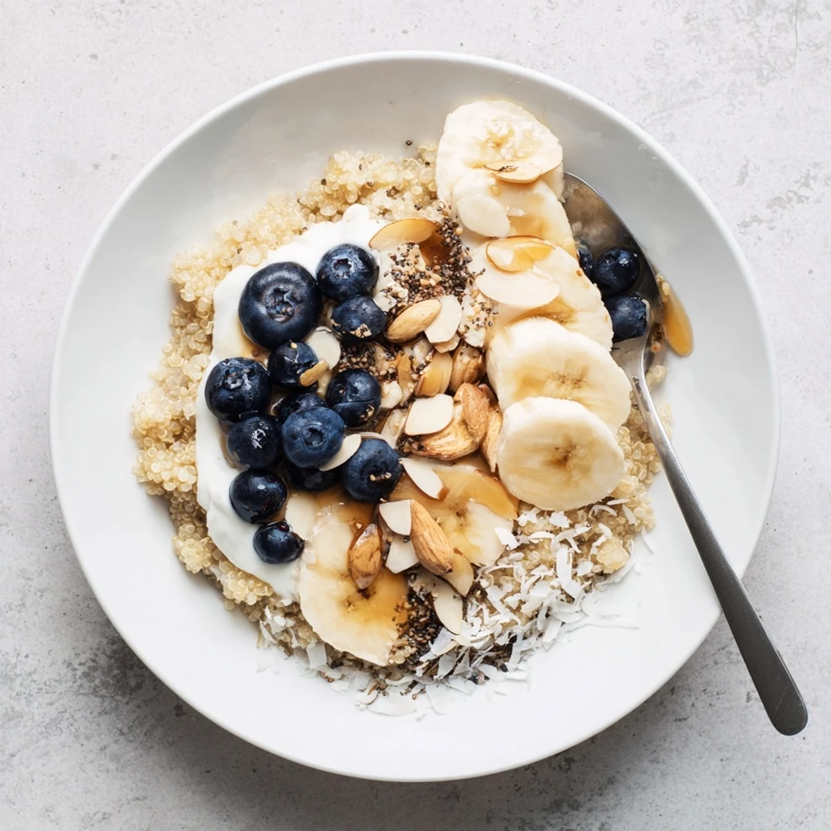 Warm Blueberry Quinoa Breakfast Bowl drizzled with sweet maple syrup and sprinkled chia seeds