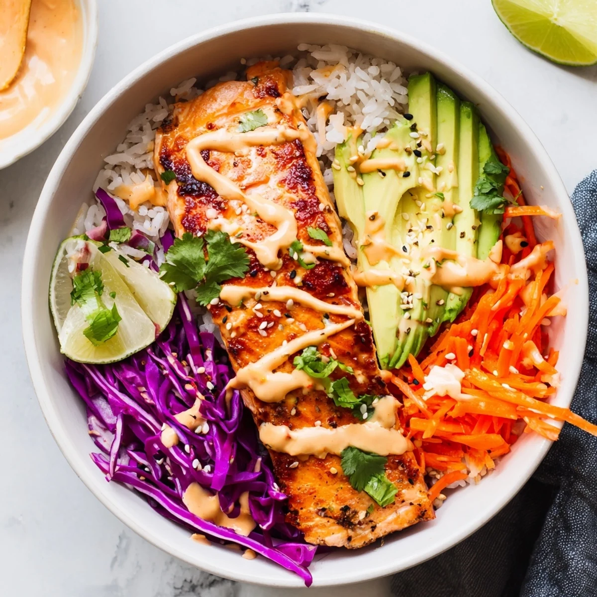 Roasted fillet over fluffy jasmine rice in Bang Bang Salmon Bowls Recipe