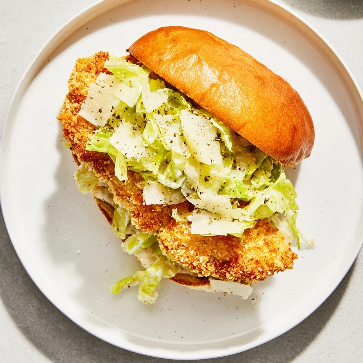 Crunchy, warm Crispy Chicken Caesar Sandwich Recipe topped with crisp romaine and Parmesan