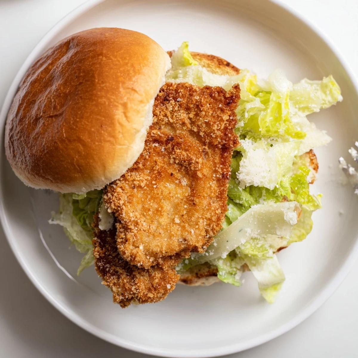 Weeknight favorite Crispy Chicken Caesar Sandwich Recipe served with lemon wedges and fries