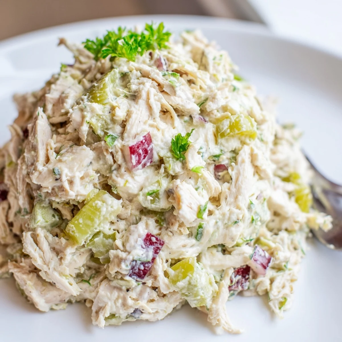 High Protein Pepperoncini Chicken Salad piled on mixed greens, tangy and crisp