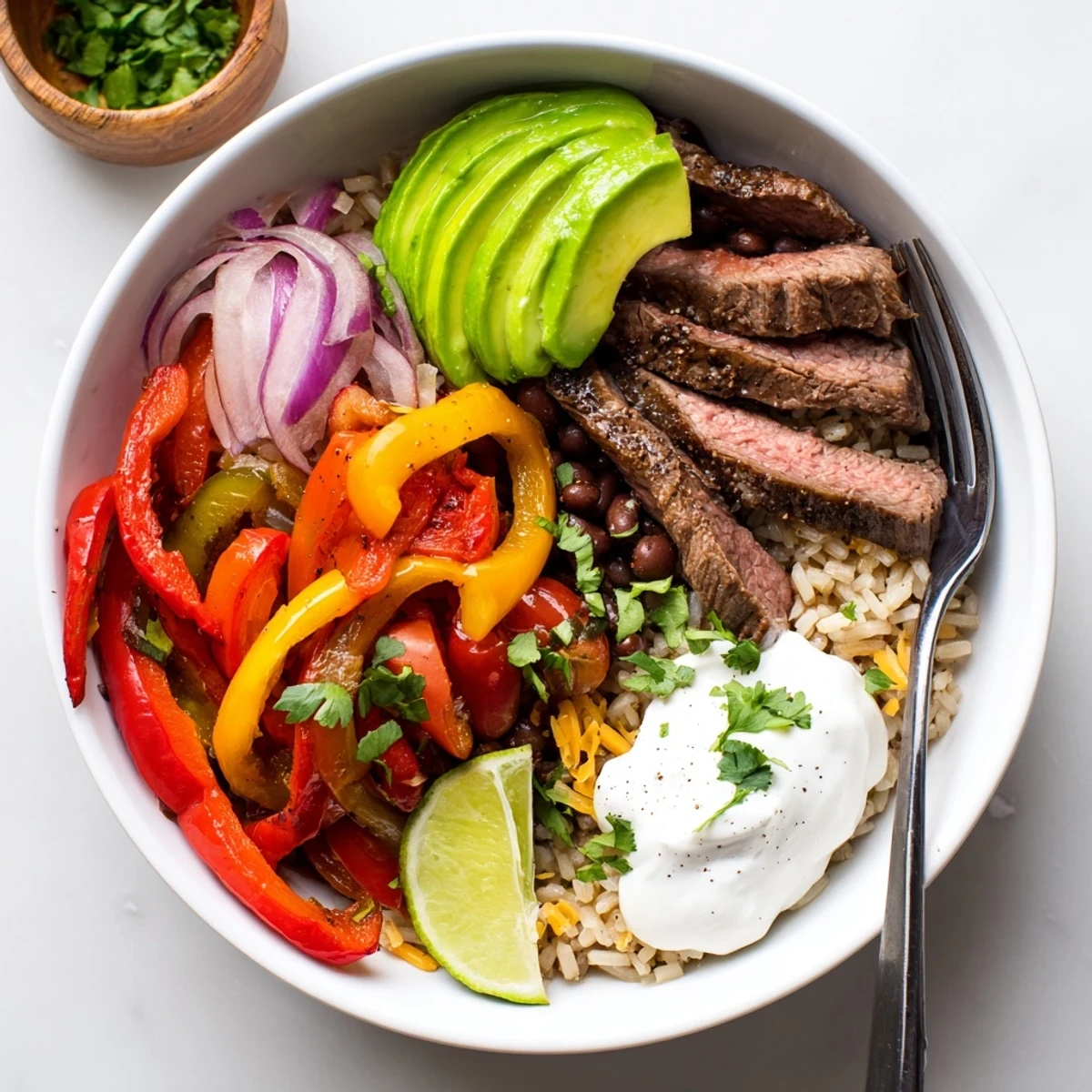 Skillet-seared Steak Fajita Power Bowls crowned with gooey cheese and yogurt