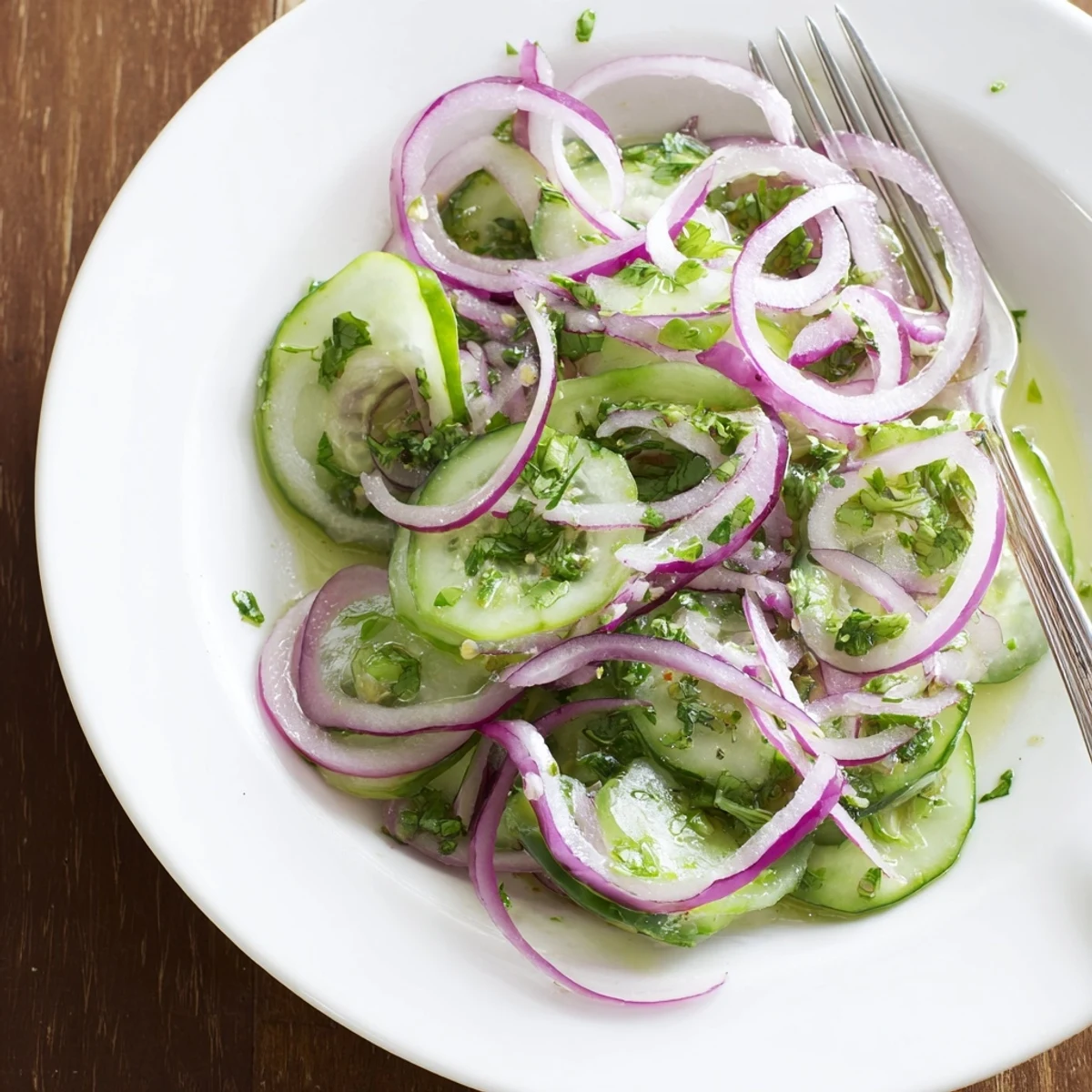 Garden fresh cucumber slices tossed with sweet honey lime dressing and red onion for a refreshing side