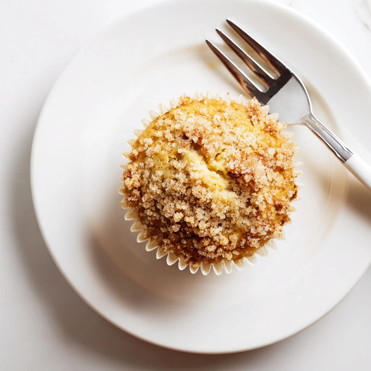 Freshly baked lemon cream cheese muffins with moist crumb and tangy cream cheese center
