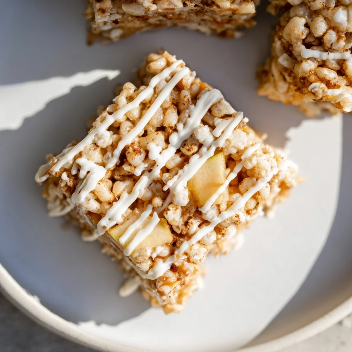 Chewy marshmallow Apple Pie Rice Krispie Treats squares with caramelized cinnamon apple pieces throughout