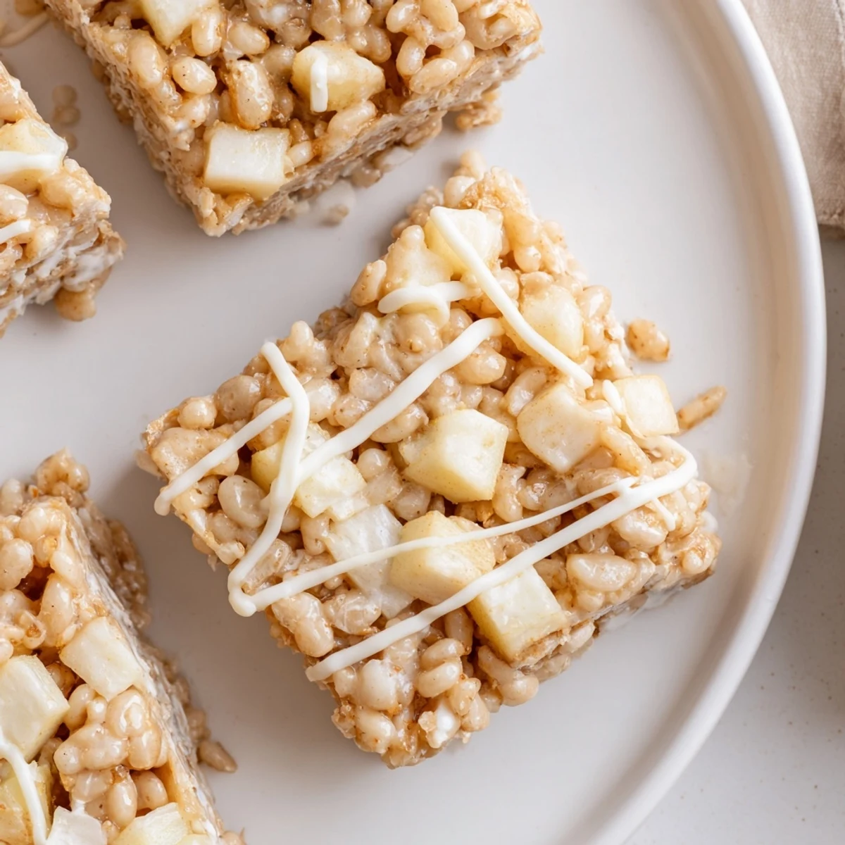 Gooey Apple Pie Rice Krispie Treats bar showing crispy rice cereal and spiced apple filling