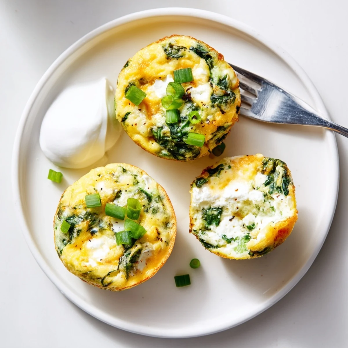Freshly baked Savory Spinach Feta Egg Bites in muffin tin, golden, aromatic.