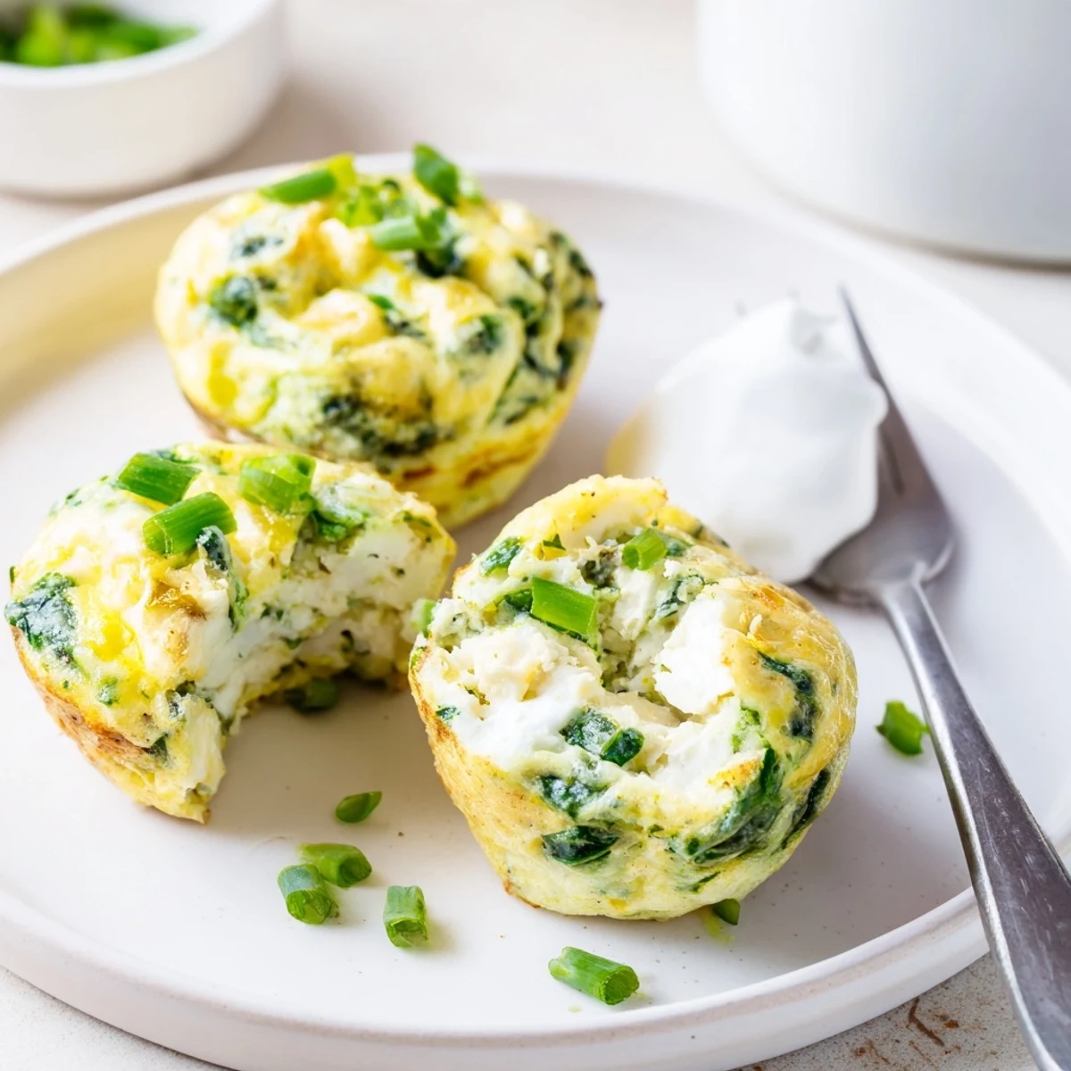 Savory Spinach Feta Egg Bites steaming on a plate, fluffy, tangy finish.
