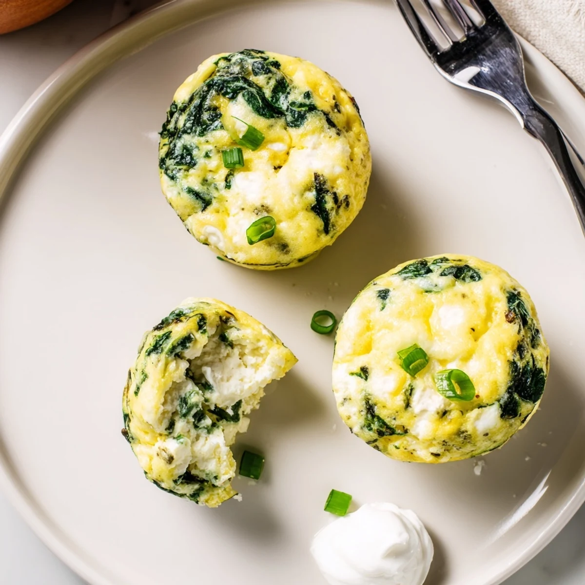 Savory Spinach Feta Egg Bites served warm with tomato salsa, creamy yogurt.