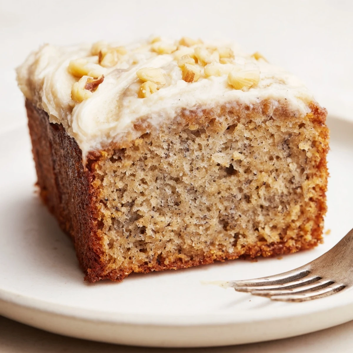 Sliced Moist Banana Cake served with cream cheese frosting and steaming coffee