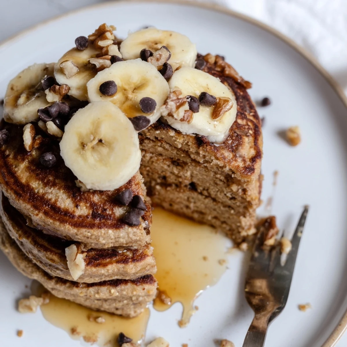 Warm Protein Banana Pancakes, fluffy and golden, topped with sliced banana