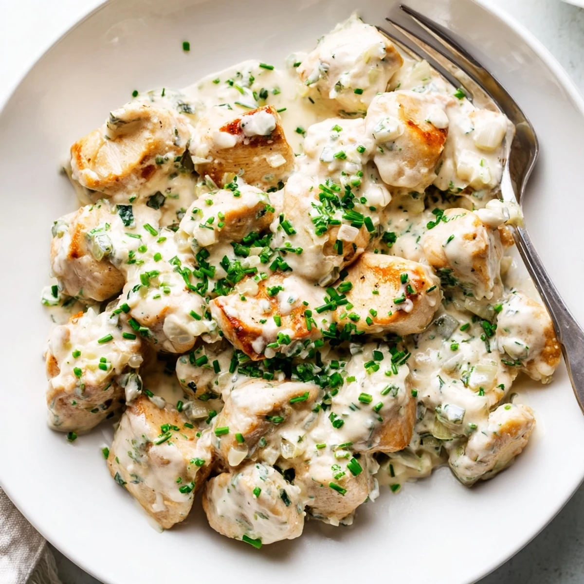 Creamy cream cheese chicken breasts smothered in a rich, golden Parmesan herb sauce