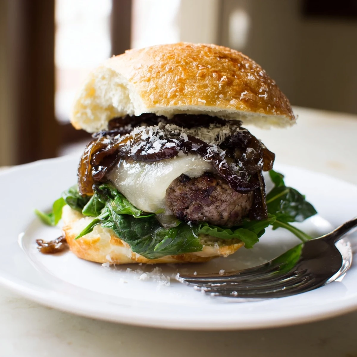 Seared filet mignon sliders piled on freshly baked garlic parmesan rolls with gooey Swiss cheese