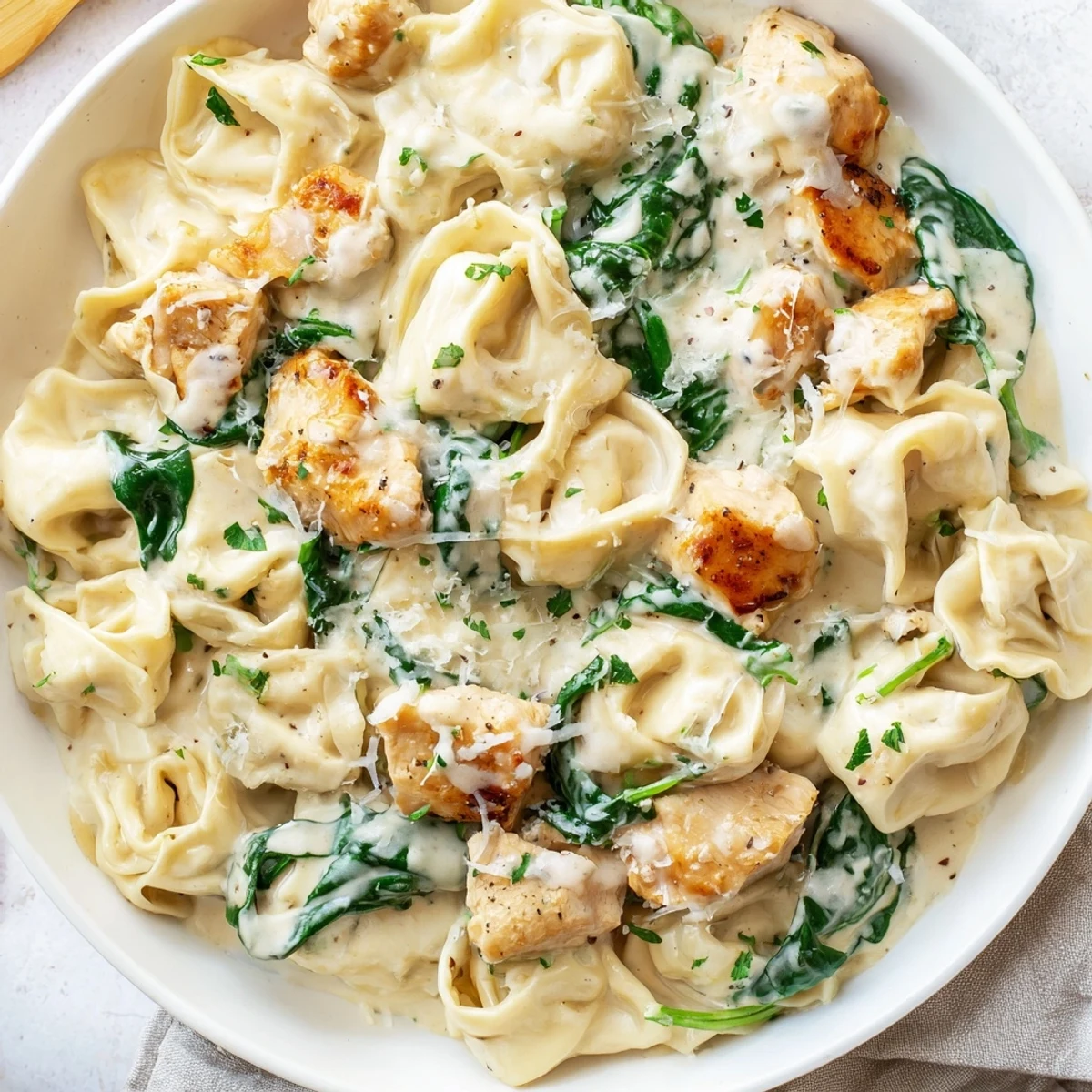 Cheesy tortellini and seared chicken breast coated in a velvety garlic cream sauce