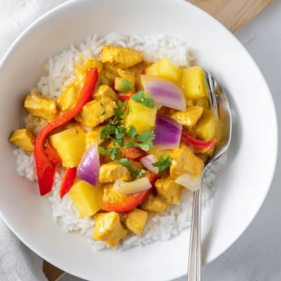 Tropical Dinner Delight served over fluffy jasmine rice with colorful bell peppers and cilantro
