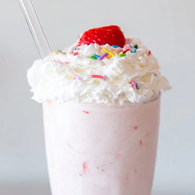 Creamy strawberry milkshake swirled with ripe berries and served ice-cold